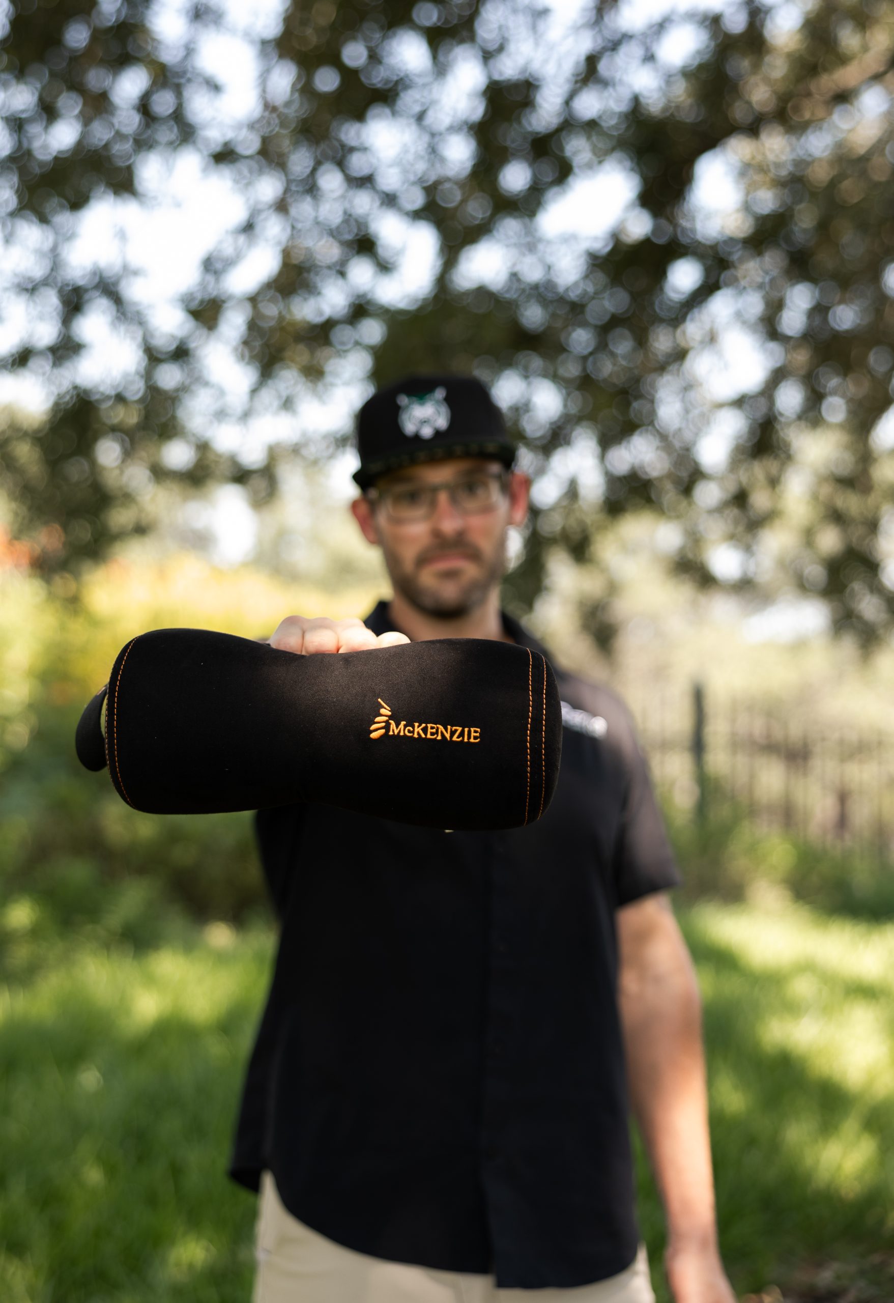 Dr. Spencer Noble of Revive Spine & Sport holding a McKenzie support